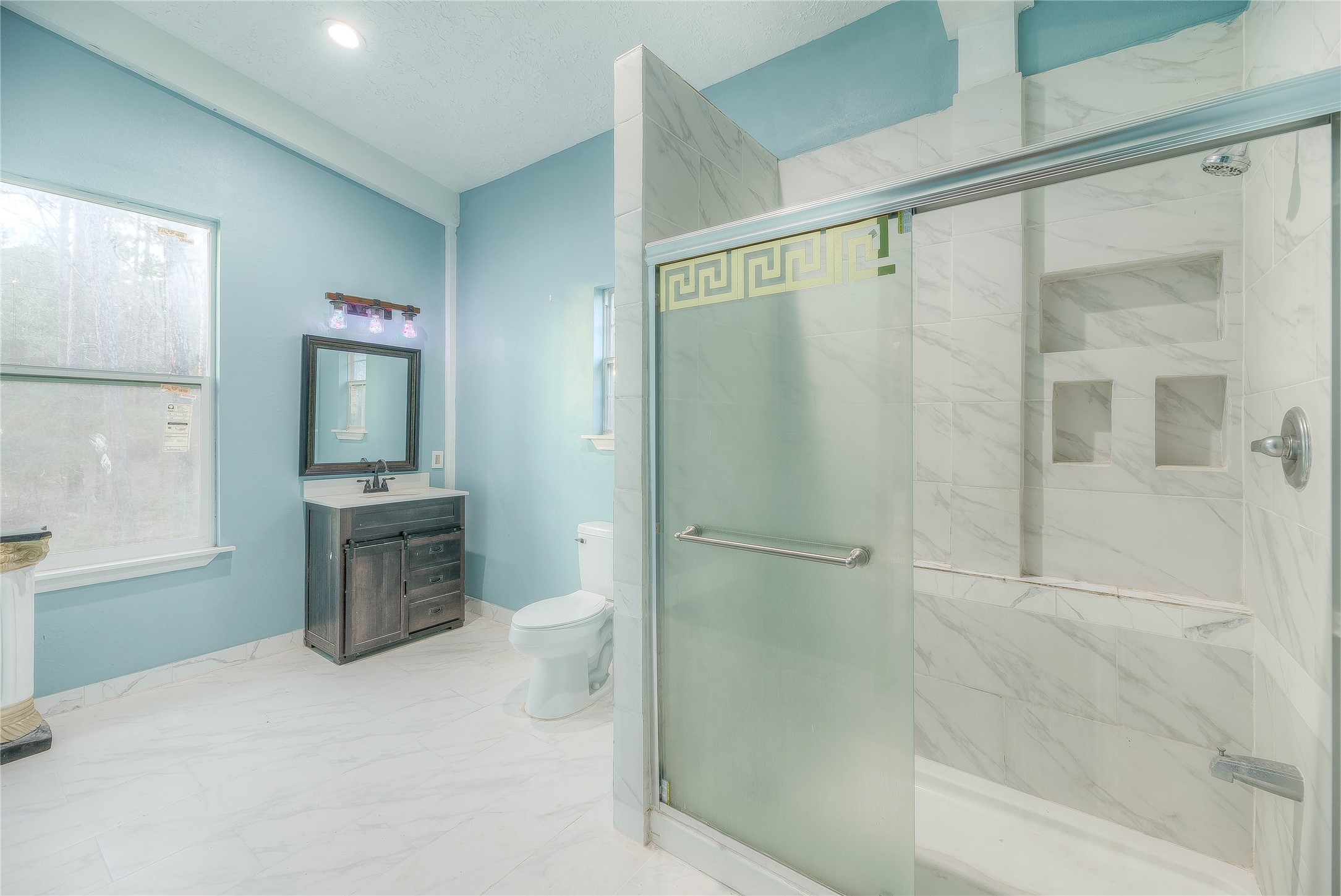 228 1 Such Road Livingston, TX 77351 - Photo 16 of 35 a bathroom with a granite countertop sink a mirror and a shower