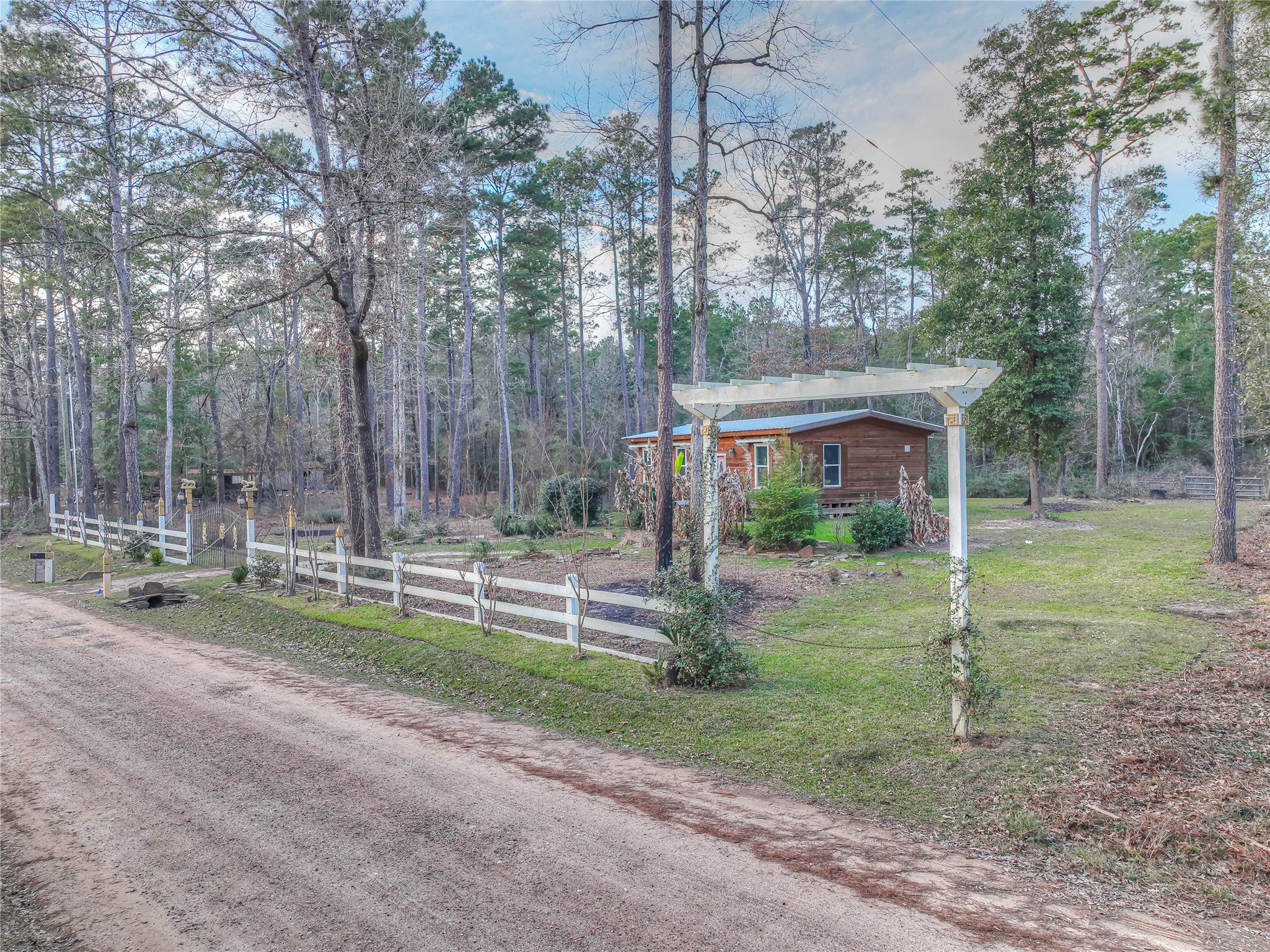 228 1 Such Road Livingston, TX 77351 - Photo 24 of 35 a view of a house with backyard and a tree