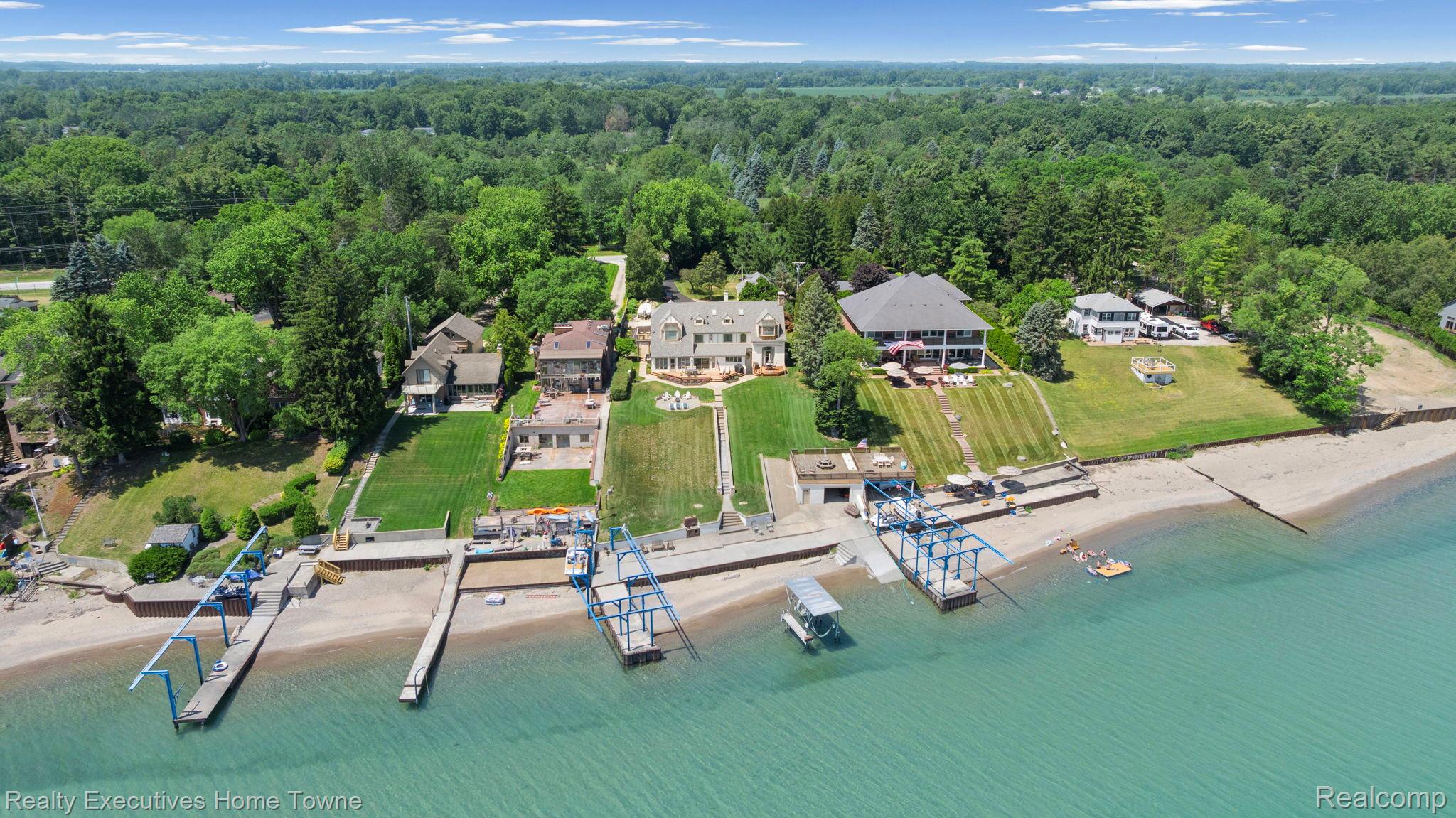 8308 Lakeshore Road Fort Gratiot, MI 48059 - Photo 20 of 79 Waterfront property featuring multiple boat docks, private beach access, and expansive green lawns
