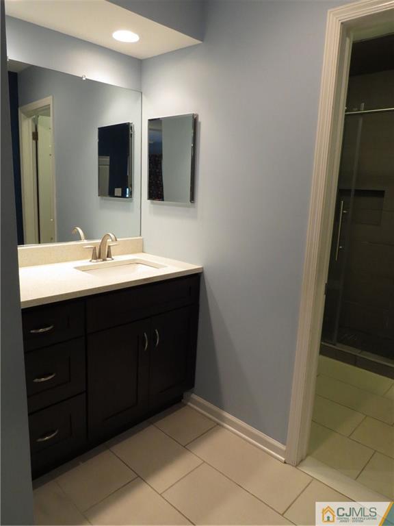 908 Timber Oaks Road Edison, NJ 08820 - Photo 14 of 20 a bathroom with a double vanity sink and mirror