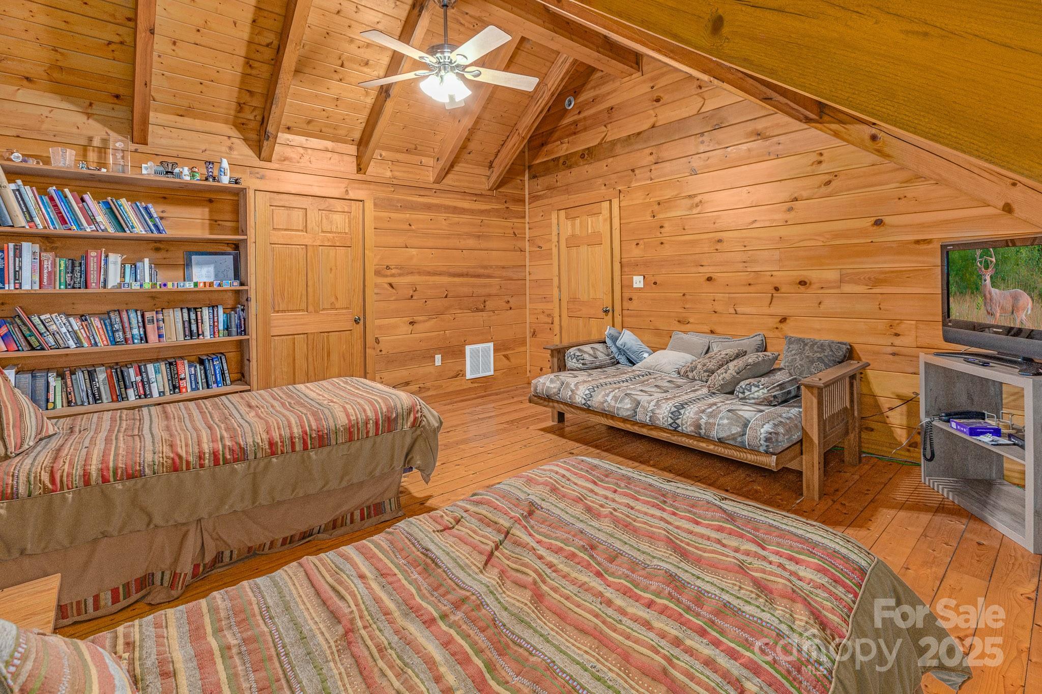 8331 Sugar Hill Road Marion, NC 28752 - Photo 15 of 36 a bedroom with bed and a book shelf