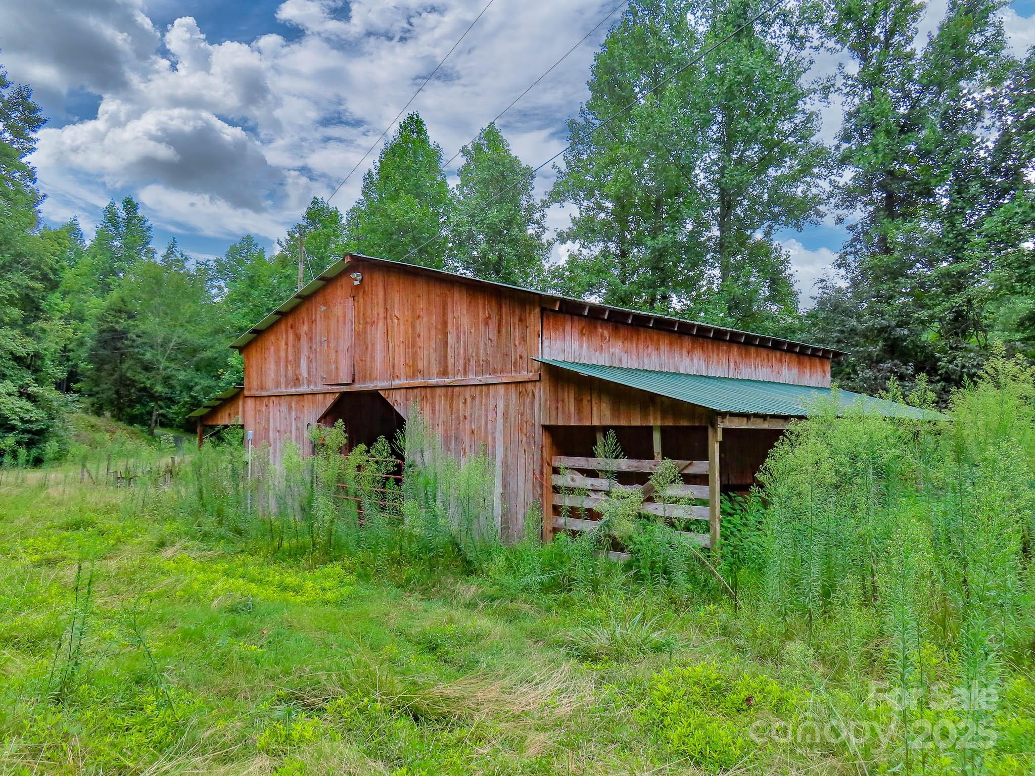 8331 Sugar Hill Road Marion, NC 28752 - Photo 23 of 36 a backyard of a house with plants and wooden fence