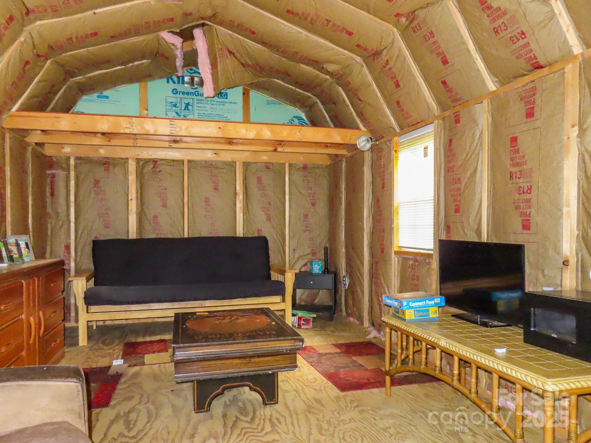 8331 Sugar Hill Road Marion, NC 28752 - Photo 27 of 36 a bedroom with furniture and a flat screen tv