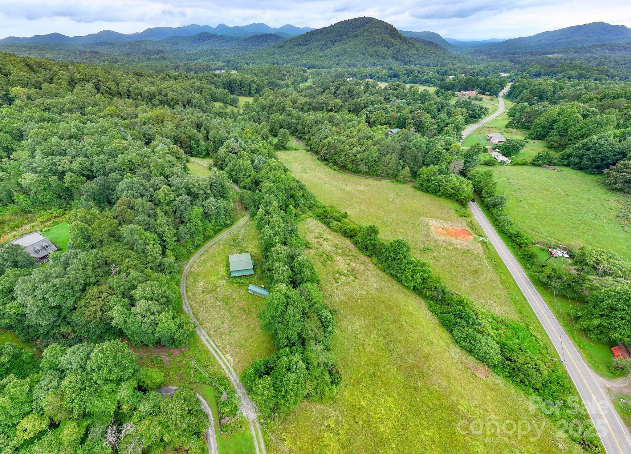 8331 Sugar Hill Road Marion, NC 28752 - Photo 35 of 36 a view of a lush green field with a view of mountains in the background