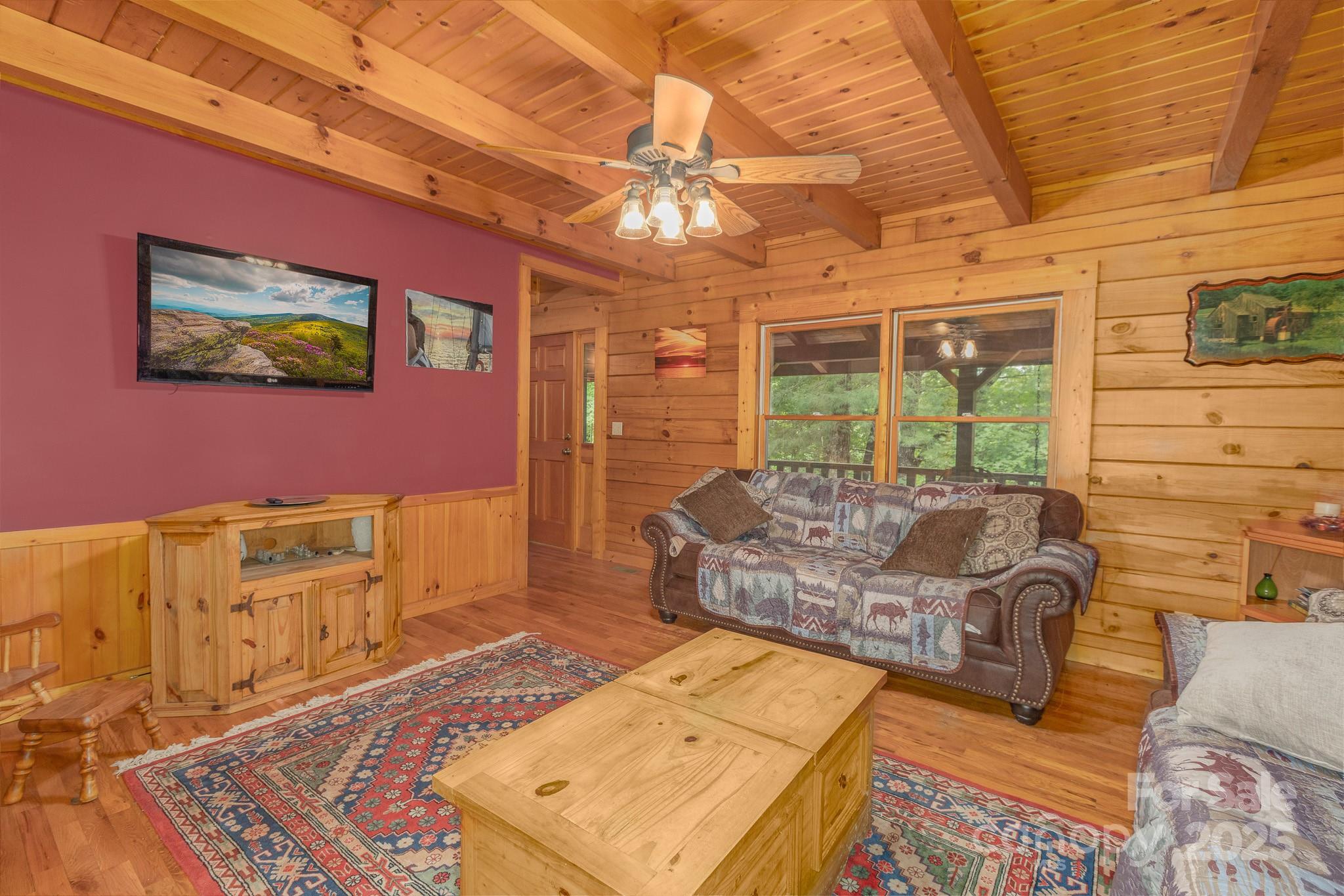 8331 Sugar Hill Road Marion, NC 28752 - Photo 9 of 36 a living room with furniture and a chandelier
