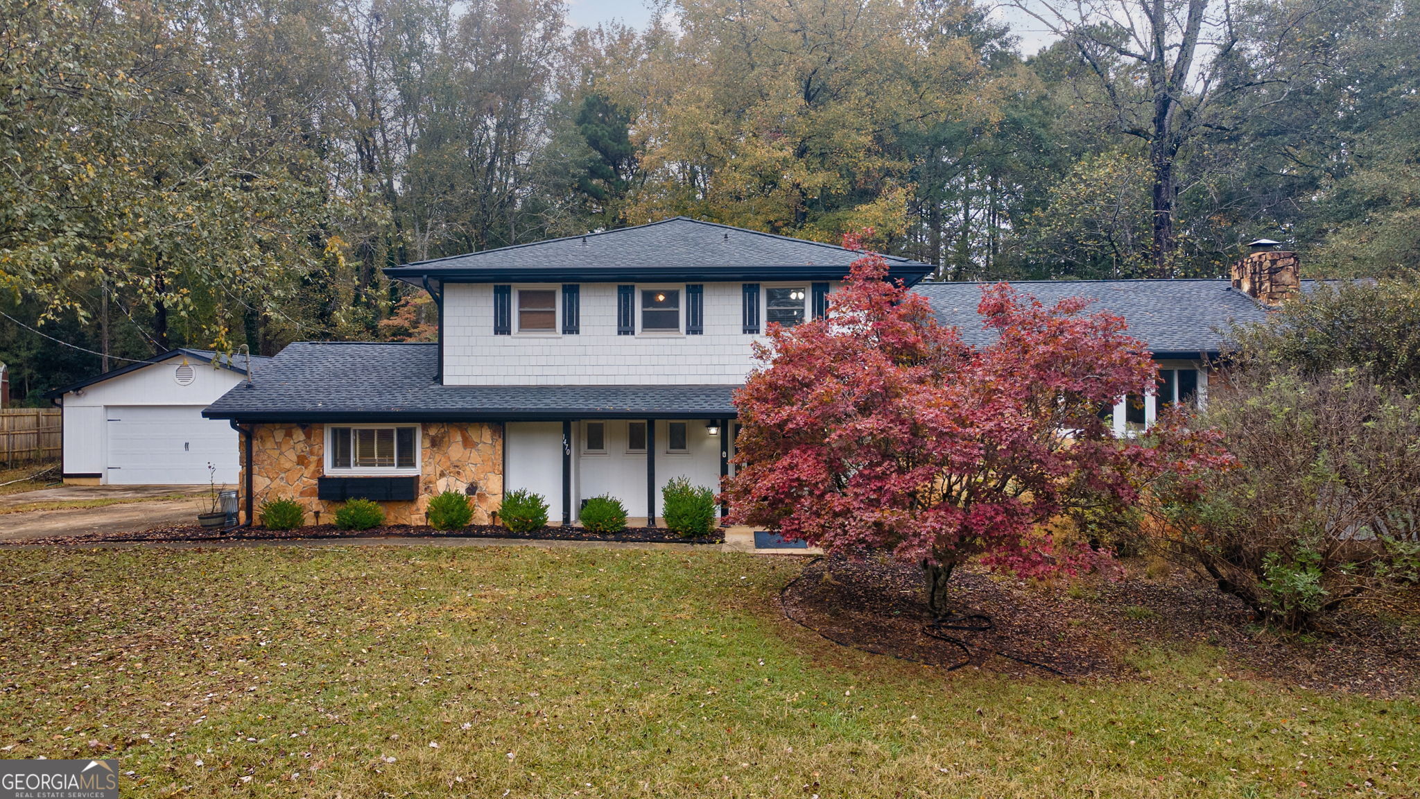 a front view of a house with a garden