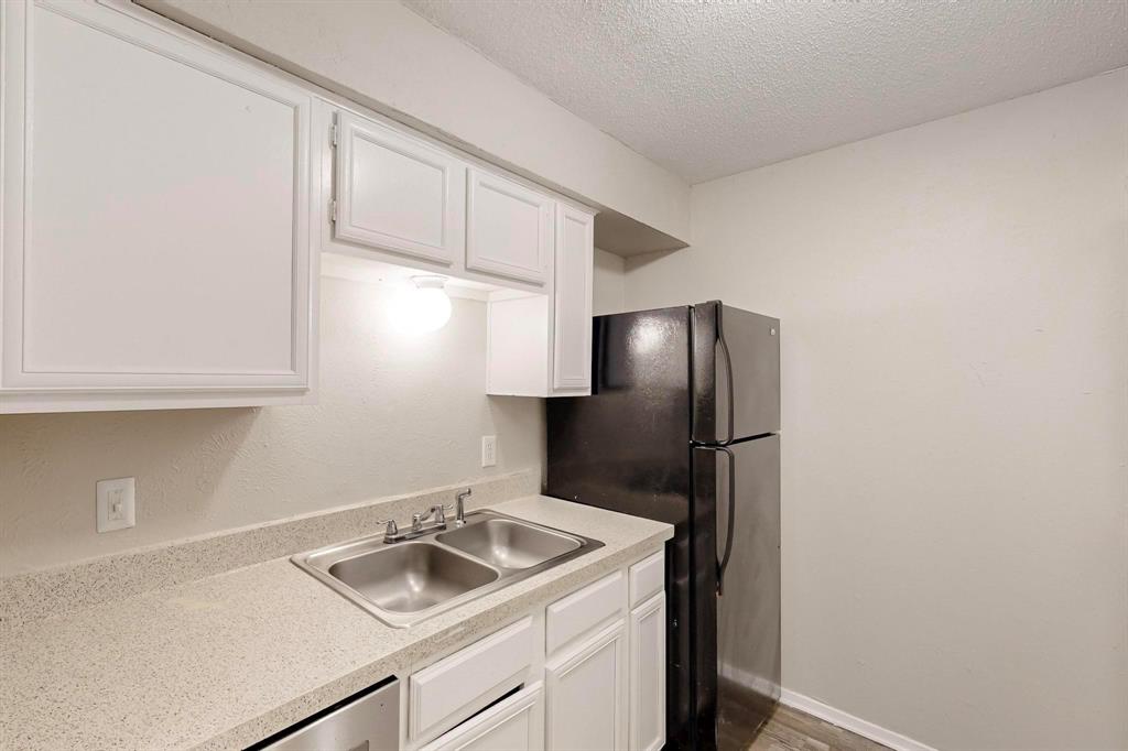 9696 Walnut Street, Unit 1402 Dallas, TX 75243 - Photo 18 of 33 a kitchen with a sink and a refrigerator