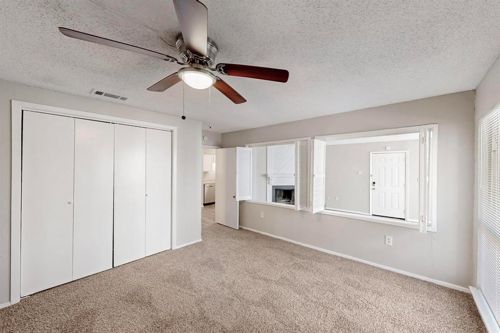 9696 Walnut Street, Unit 1402 Dallas, TX 75243 - Photo 25 of 33 an empty room with ceiling fan and windows