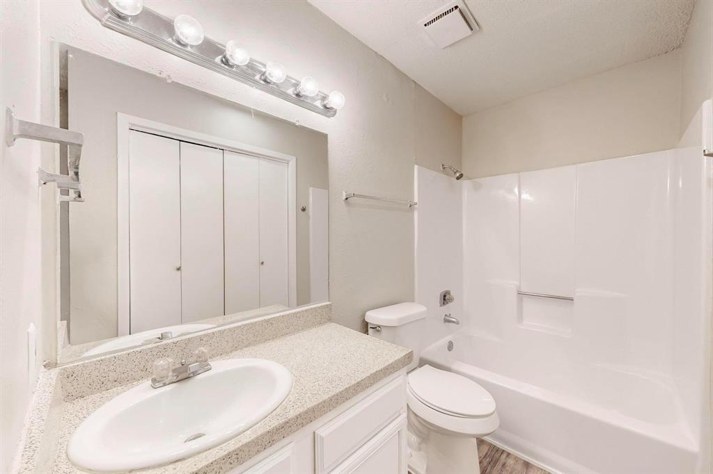 9696 Walnut Street, Unit 1402 Dallas, TX 75243 - Photo 29 of 33 a bathroom with a sink a toilet and shower