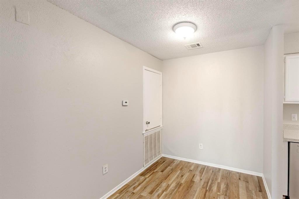 9696 Walnut Street, Unit 1402 Dallas, TX 75243 - Photo 10 of 33 a view of a room with wooden floor and a window