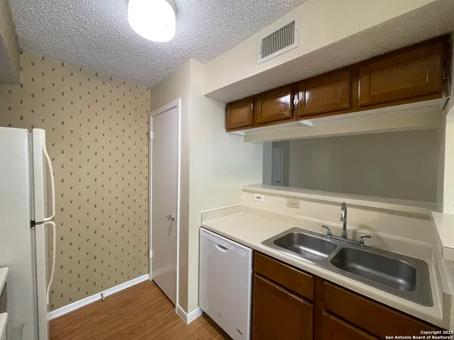 a kitchen with a sink and a refrigerator