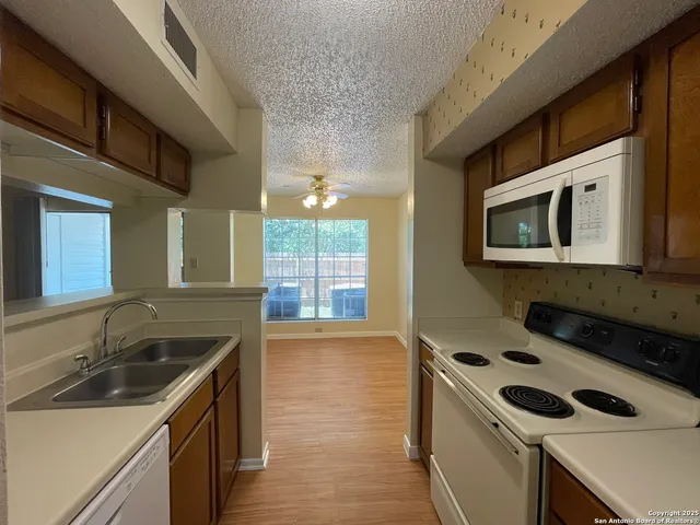 a kitchen that has a sink and a stove