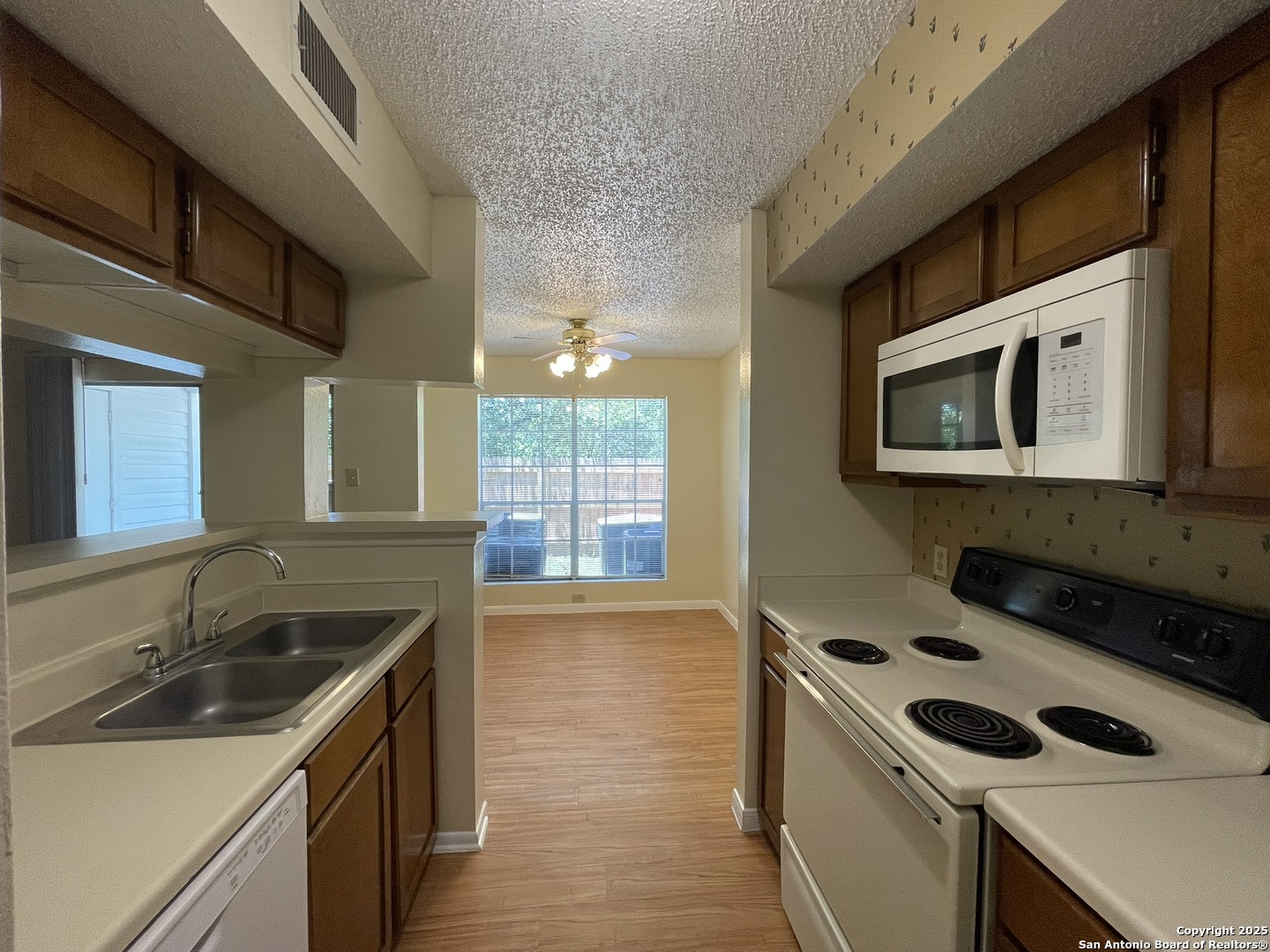 11311 Sir Winston Street, Unit 604 San Antonio, TX 78216 - Photo 12 of 24 a kitchen that has a sink and a stove