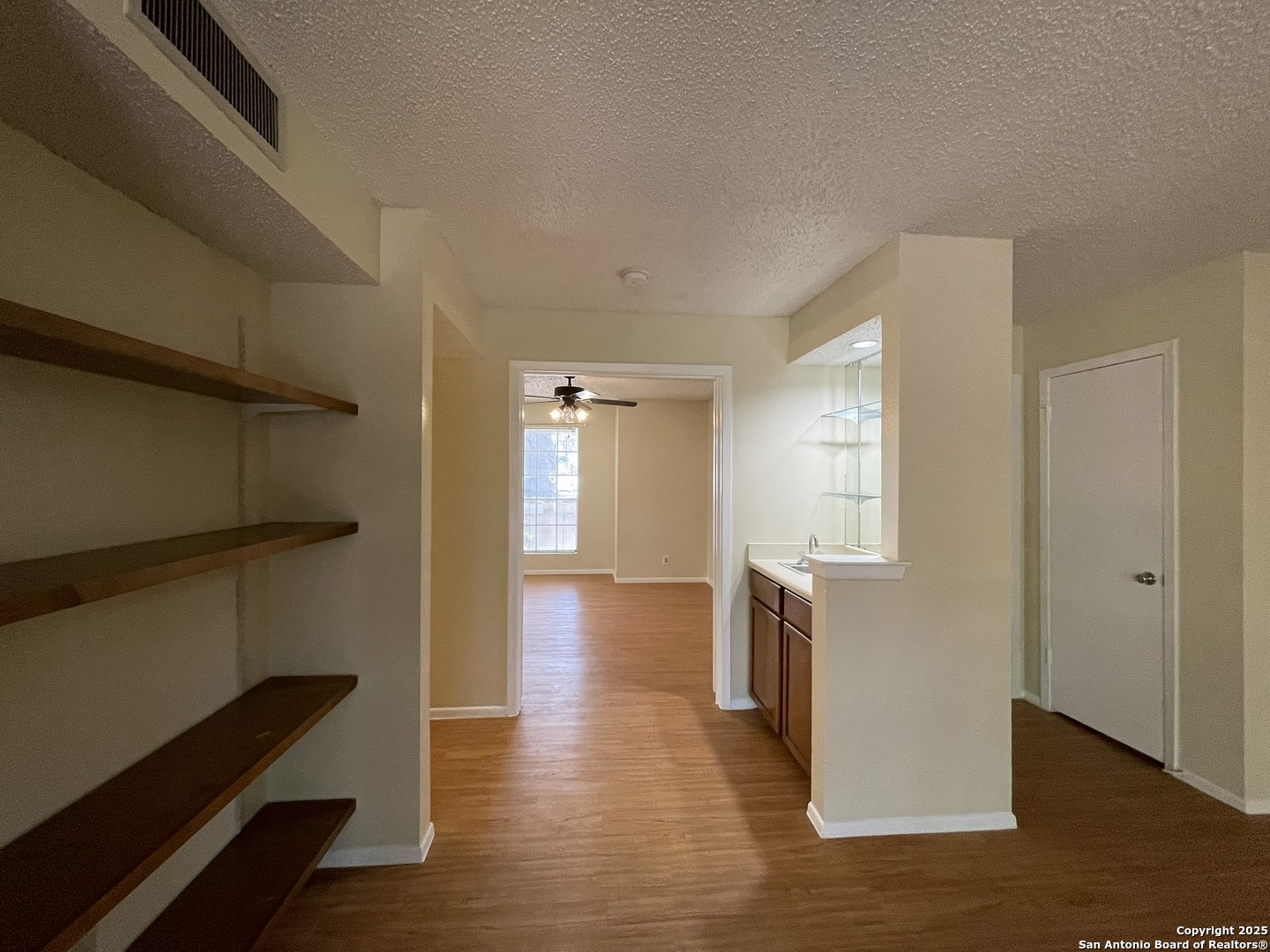 11311 Sir Winston Street, Unit 604 San Antonio, TX 78216 - Photo 13 of 24 a view of a room with wooden floor and windows