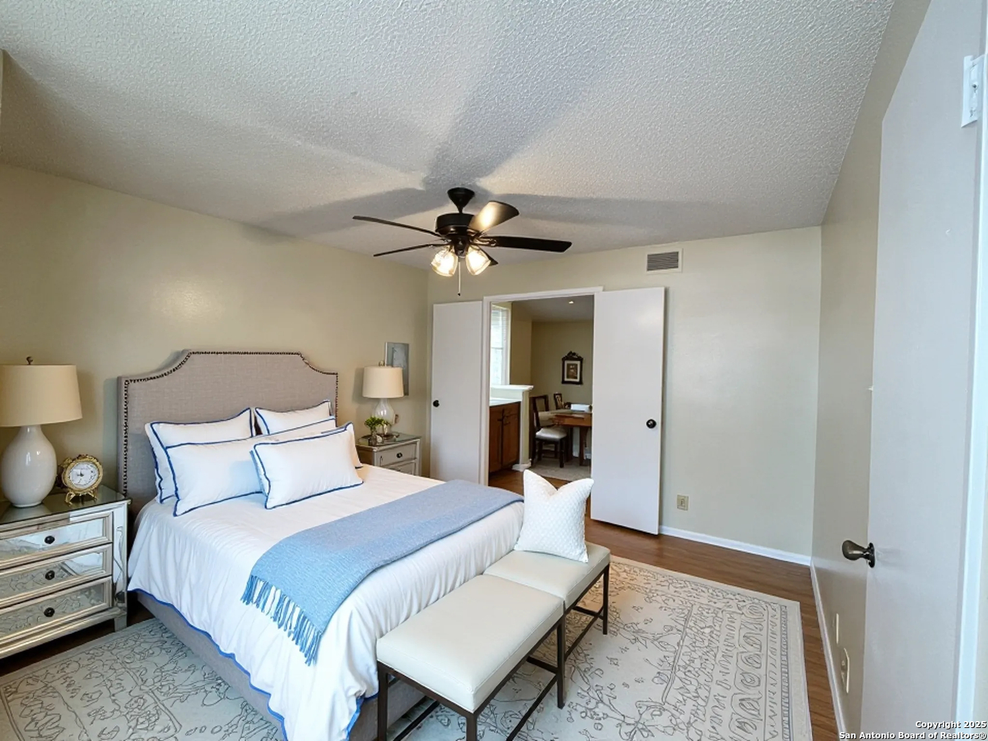 11311 Sir Winston Street, Unit 604 San Antonio, TX 78216 - Photo 18 of 24 a bedroom with a bed and a chandelier