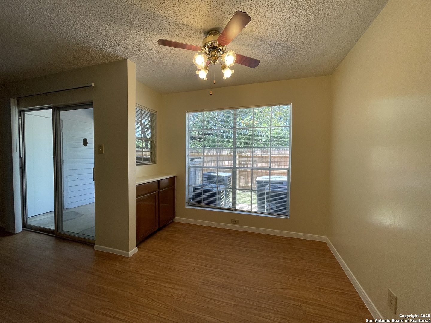 11311 Sir Winston Street, Unit 604 San Antonio, TX 78216 - Photo 8 of 24 a view of an empty room with a window and wooden floor