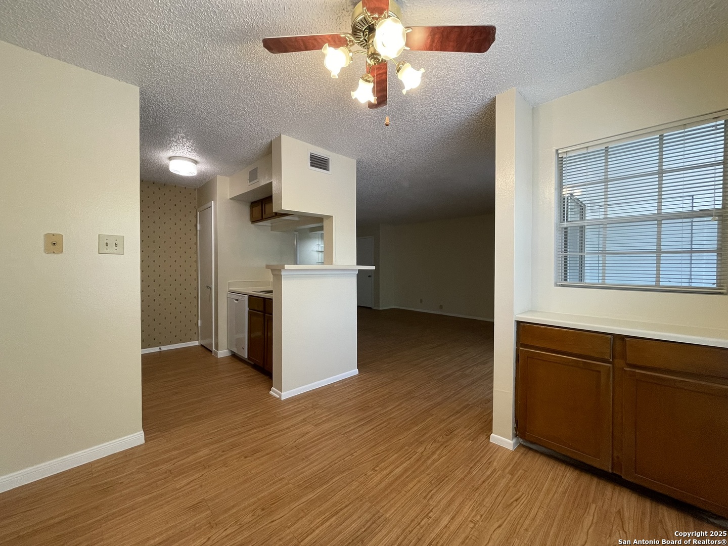 11311 Sir Winston Street, Unit 604 San Antonio, TX 78216 - Photo 9 of 24 a kitchen view with wooden floor and a large window