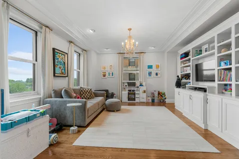 a living room with furniture and a chandelier