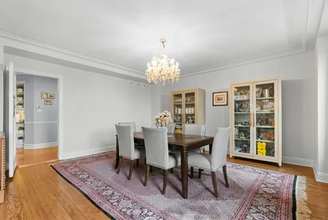 a dining room with furniture a rug and wooden floor