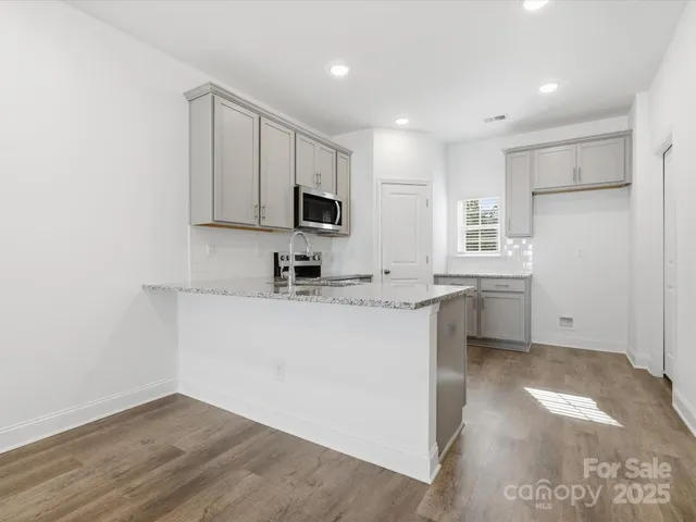 a kitchen with appliances a sink and cabinets