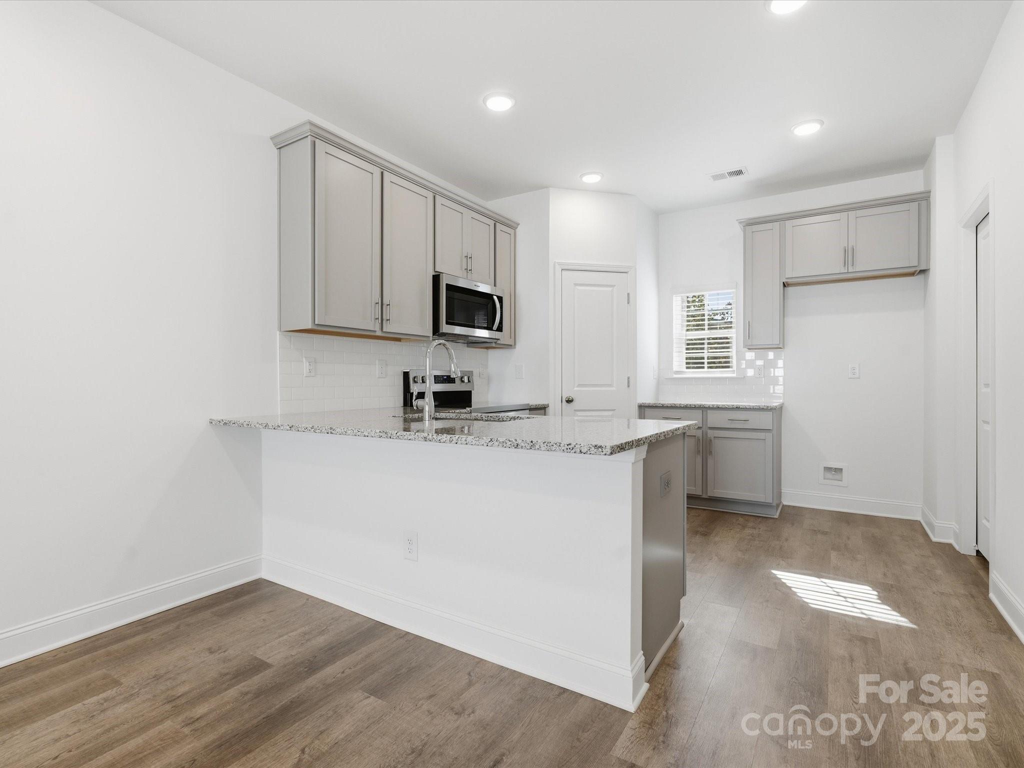 3132 Butler Hl Drive Matthews, NC 28105 - Photo 12 of 36 a kitchen with appliances a sink and cabinets