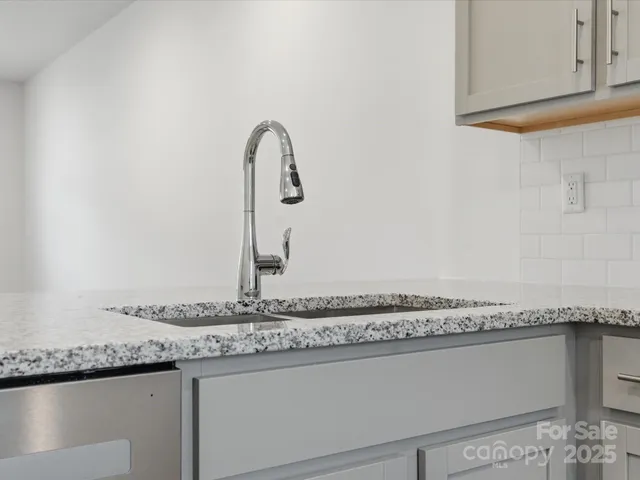 a close view of a granite countertop sink and a granite top