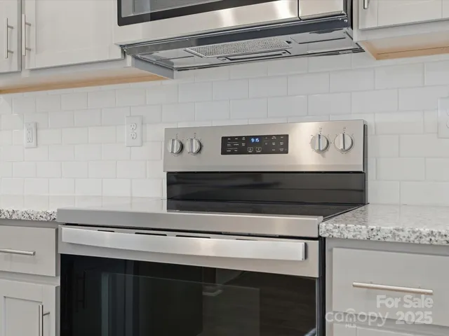 a stove top oven sitting inside of a kitchen