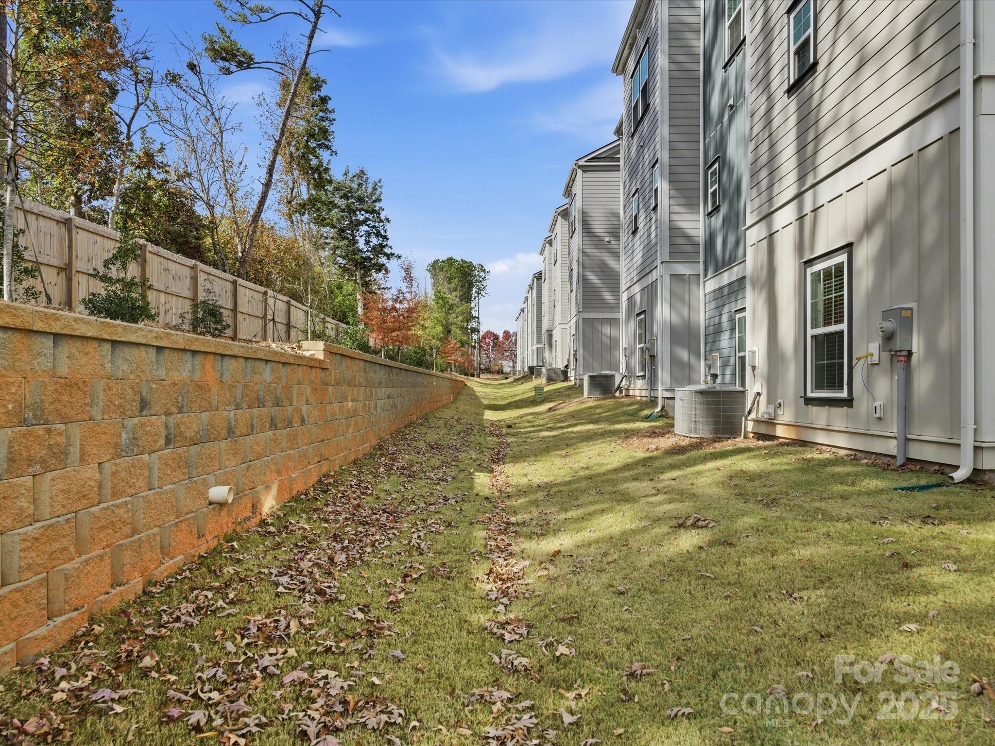 3132 Butler Hl Drive Matthews, NC 28105 - Photo 35 of 36 a view of a yard with brick walls