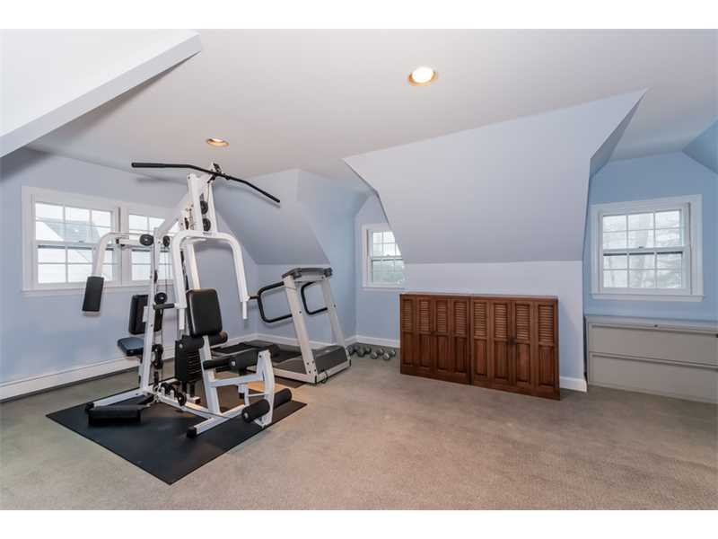 22 Maplewood Drive Darien, CT 06820 - Photo 17 of 25 a room with gym equipment and large mirror