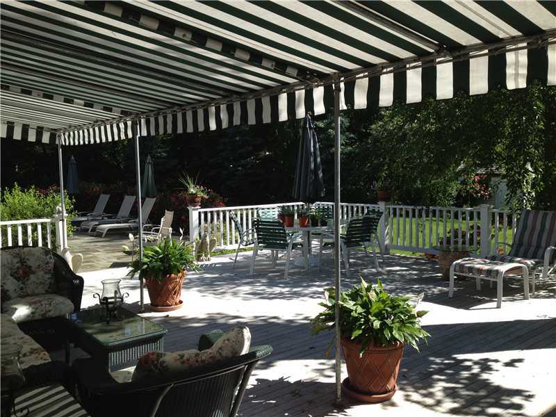 22 Maplewood Drive Darien, CT 06820 - Photo 19 of 25 a view of a chair and tables in the patio