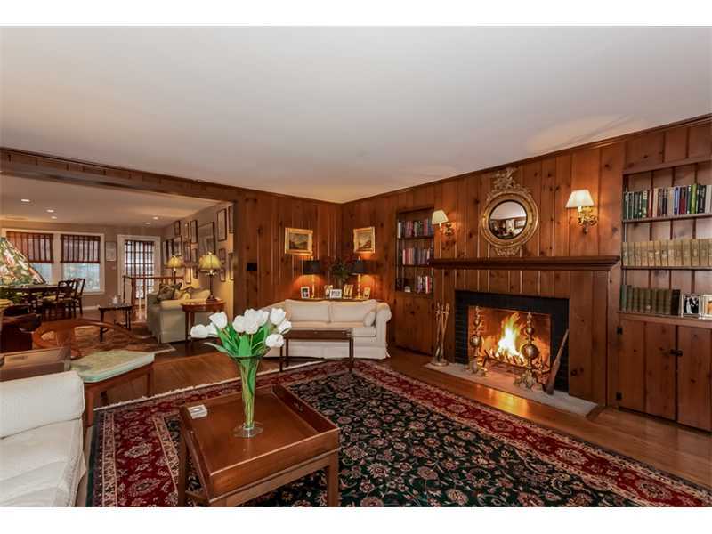 22 Maplewood Drive Darien, CT 06820 - Photo 2 of 25 a living room with furniture a fireplace and a floor to ceiling window