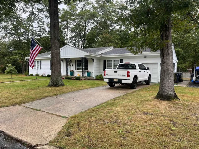 a car parked in front of white house
