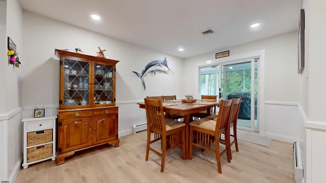 a view of a dining room with furniture and window