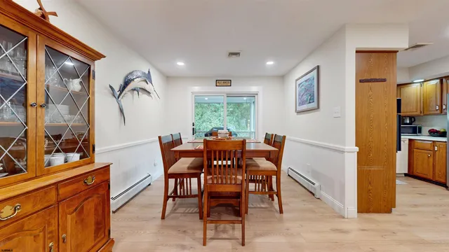 a view of a dining room with furniture and a window