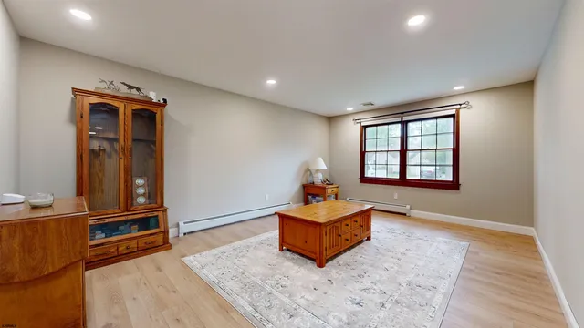 a living room with blue lights with furniture and wooden floor