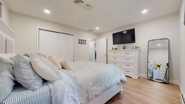 a bedroom with a bed and a television