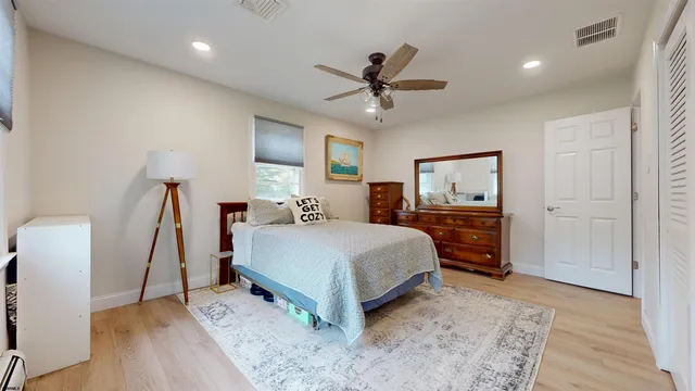 a living room with a bed furniture and a wooden floor