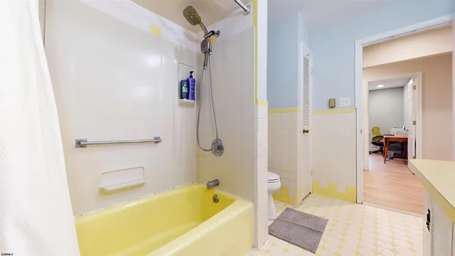 a bathroom with a tub a sink and a shower