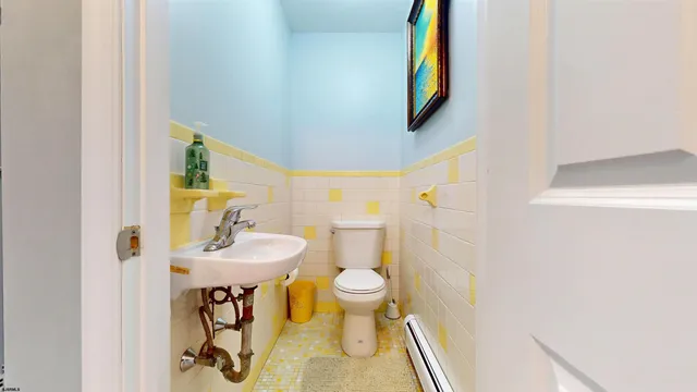 a bathroom with a sink toilet and mirror