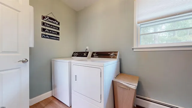 a view of a storage and utility room with washer and dryer
