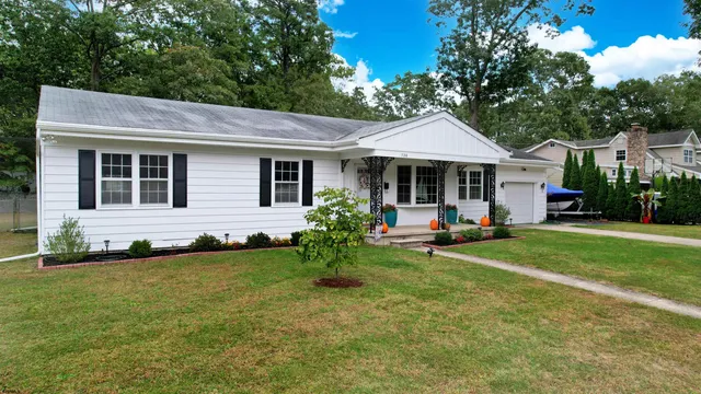a view of a house with backyard sitting area and garden