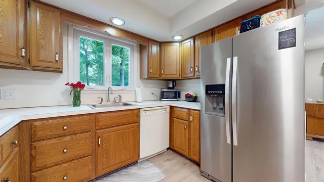 a kitchen with stainless steel appliances granite countertop a refrigerator sink and cabinets