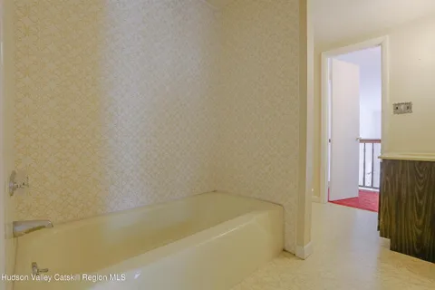 a bath tub sitting next to a white sink and vanity