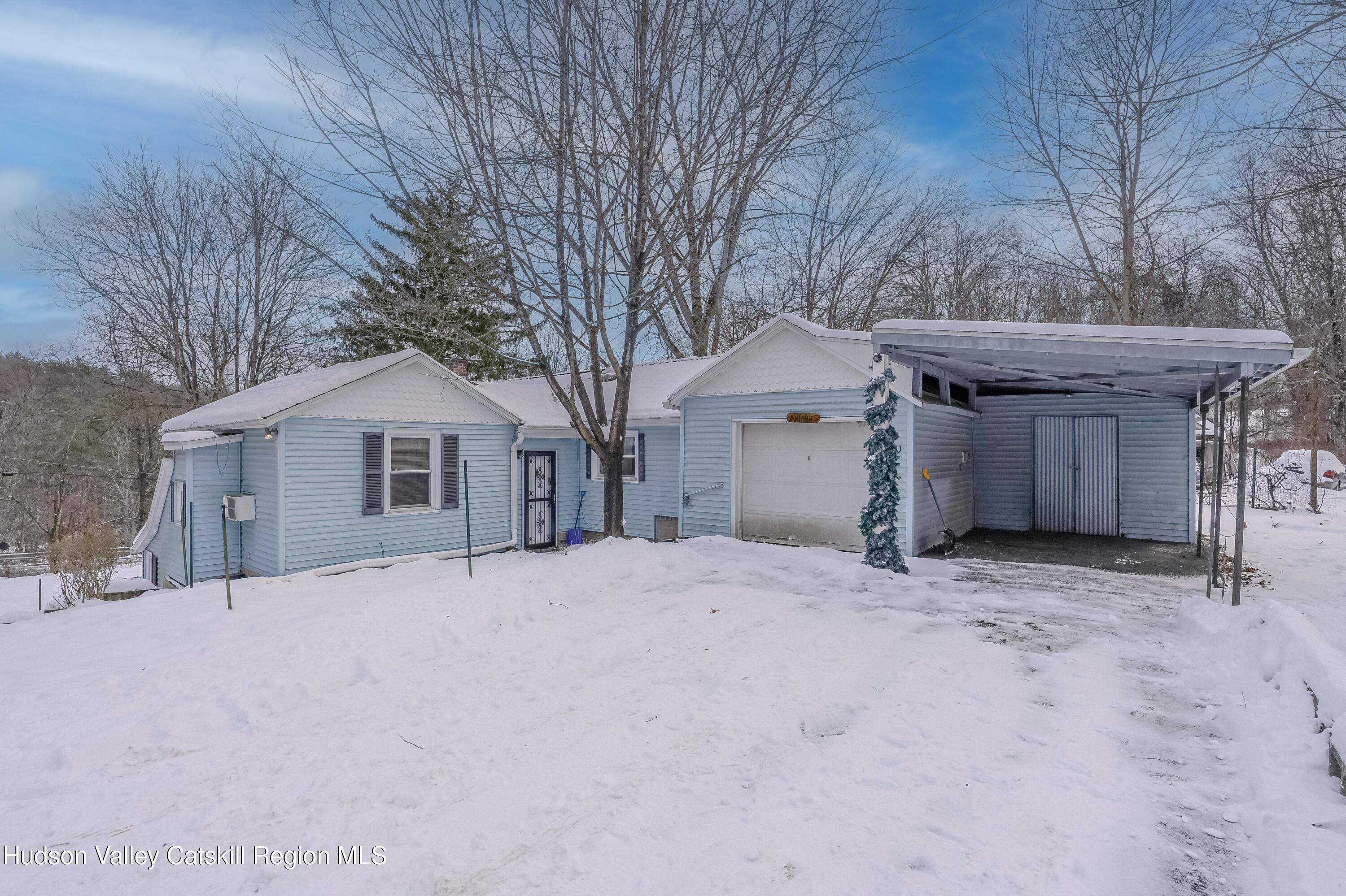 89 Cottekill Road Cottekill, NY 12419 - Photo 2 of 29 a front view of a house with a yard and garage