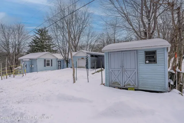 a view of white house with a snow and yard