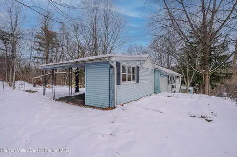 a view of a house with a snow in the yard