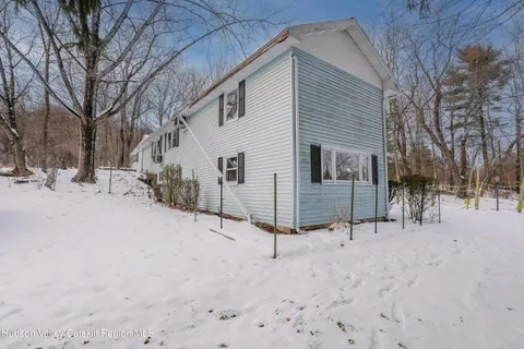 a view of a house with a snow in the yard