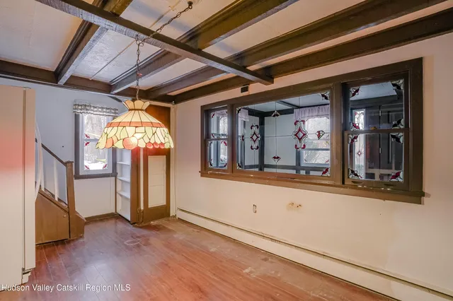 a view of an entryway with wooden floor