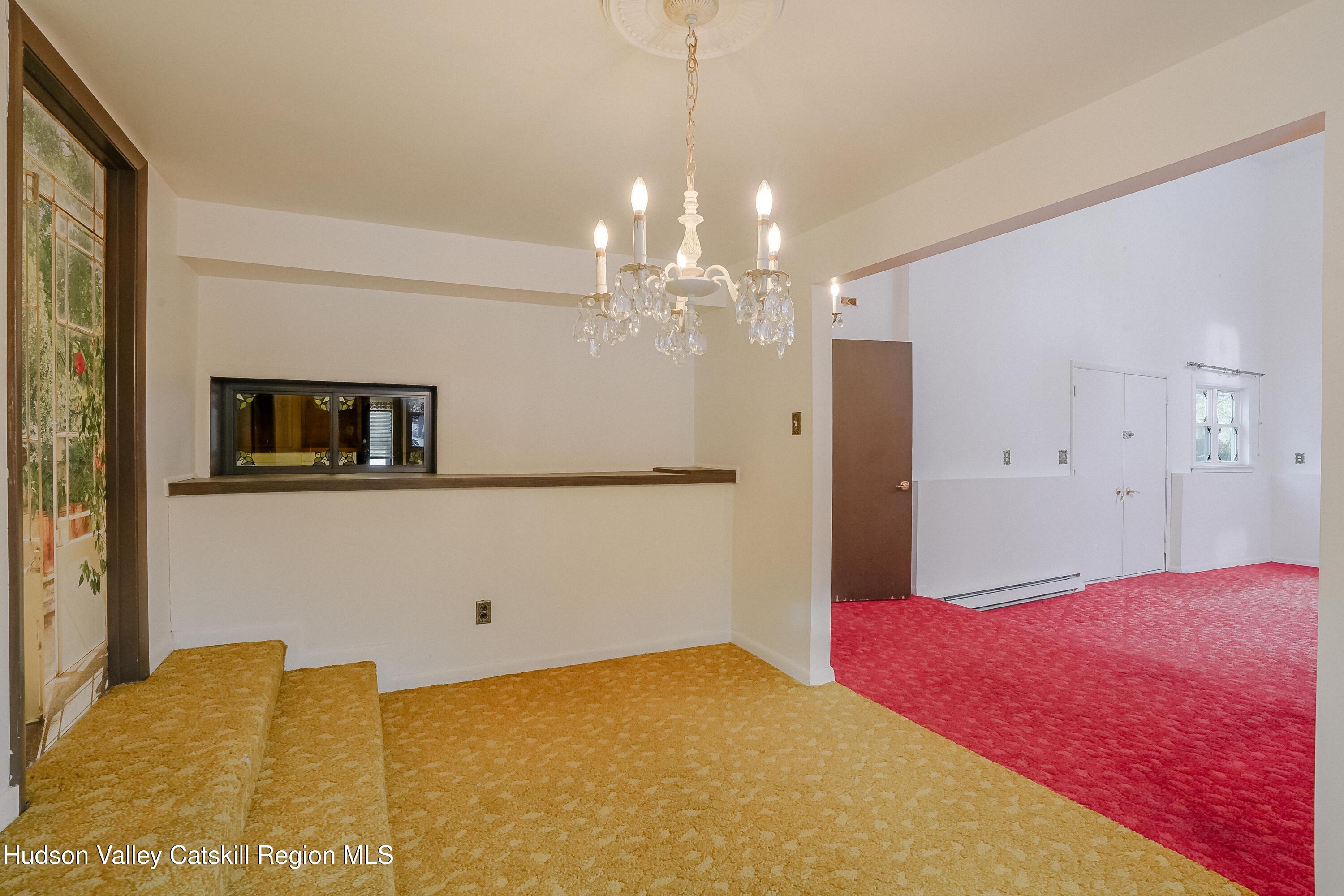 89 Cottekill Road Cottekill, NY 12419 - Photo 9 of 29 a bedroom with a bed and a chandelier