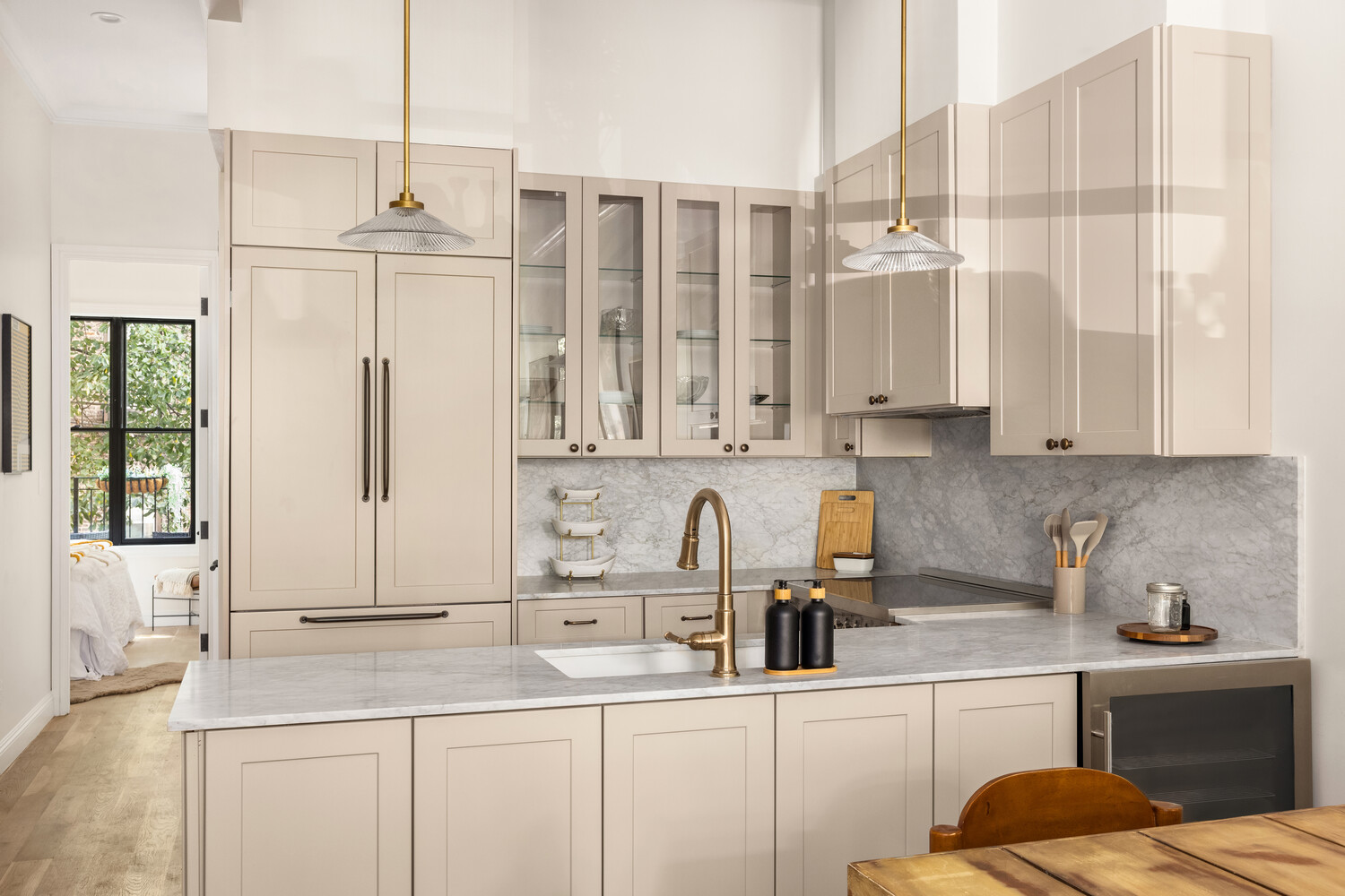 378 8th Street, Unit 3 Brooklyn, NY 11215 - Photo 8 of 15 a kitchen with stainless steel appliances kitchen island granite countertop a sink a stove and white cabinets